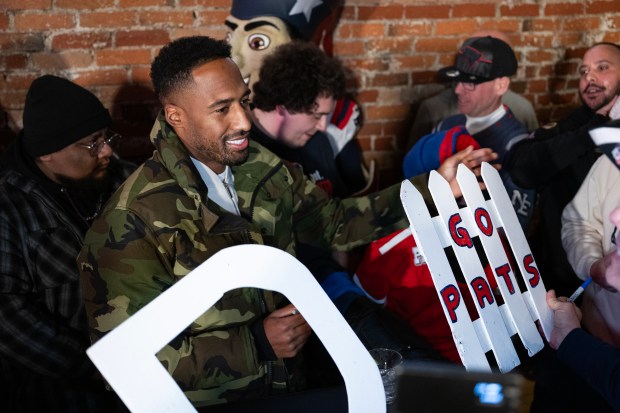 Former New England Patriots cornerback Logan Ryan signs autographs for fans on Saturday at Jackson's LODO in Denver. (Photo by Timothy Hurst/The Denver Post)