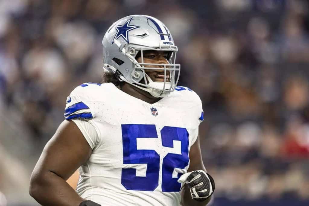 Dallas Cowboys football player in full gear during an NFL game, showcasing team colors, helmet, and jersey with number 52, representing Inside The Star football coverage.