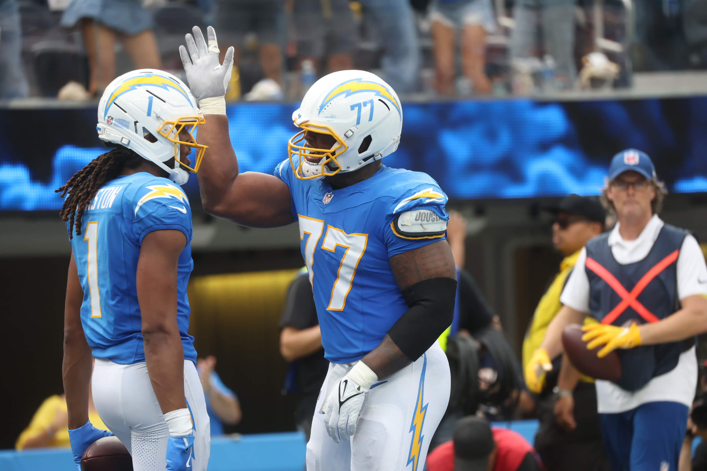 Los Angeles Chargers wide receiver Quentin Johnston (1) and Los Angeles Chargers guard Zion Johnson (77) react after a play during the first half against the Denver Broncos at SoFi Stadium.