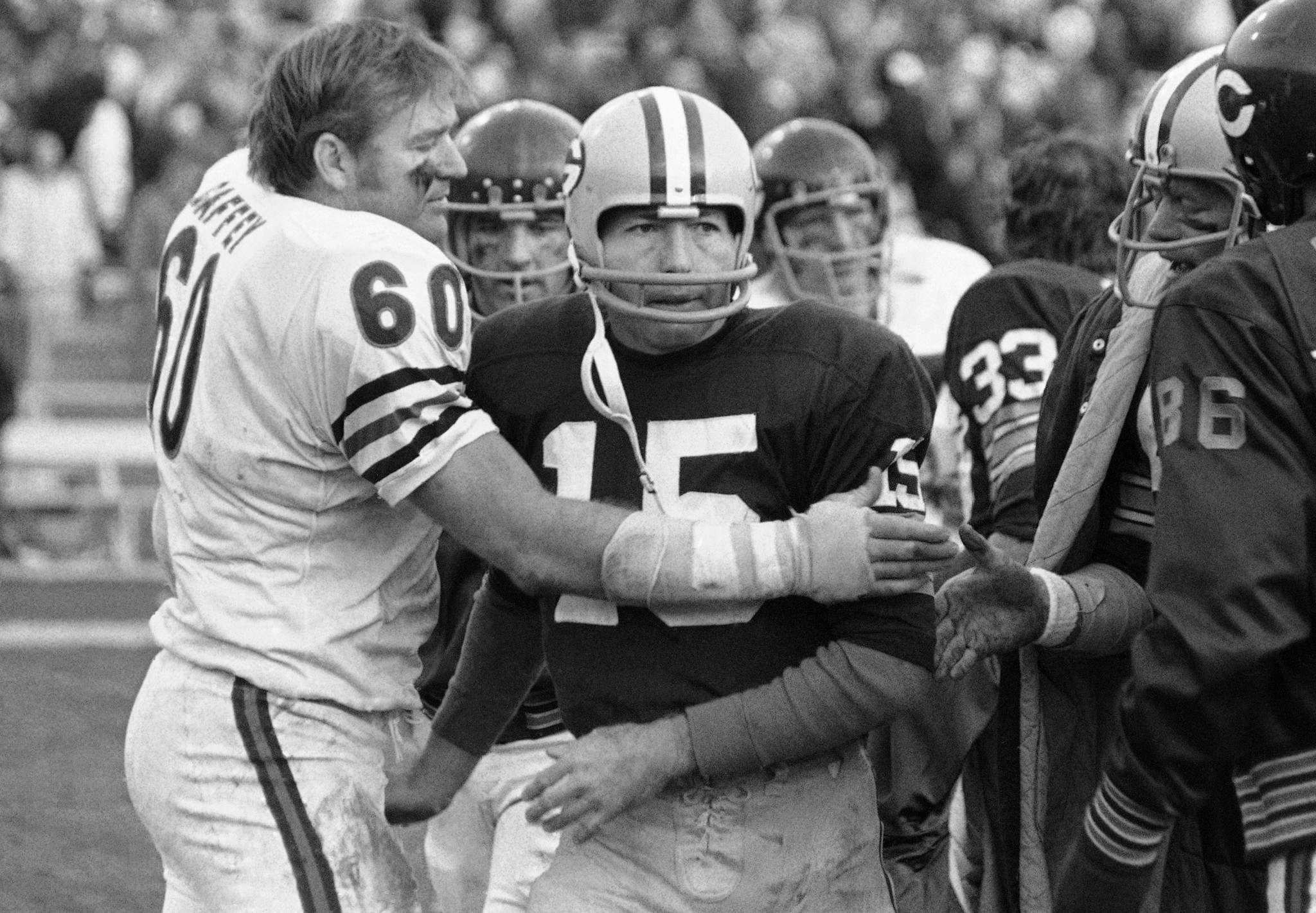 In this Nov. 16, 1970, file photo, the Bears' Lee Roy Caffey, left, congratulates Packers quarterback Bart Starr after Starr scored the winning touchdown in Green Bay.