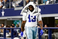 Dallas Cowboys defensive end Dante Fowler Jr. (13) walks off the field with members of the...