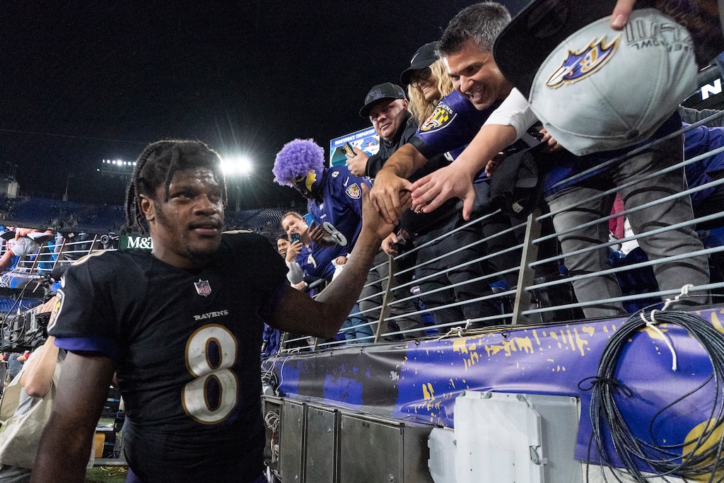 Ravens quarterback Lamar Jackson celebrates with fans after the team's 31-26 overtime win against the Indianapolis Colts on Oct. 11, 2021.