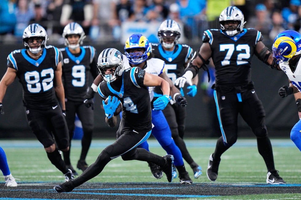 Carolina Panthers wide receiver Tetairoa McMillan (4) carries after a catch during the first...