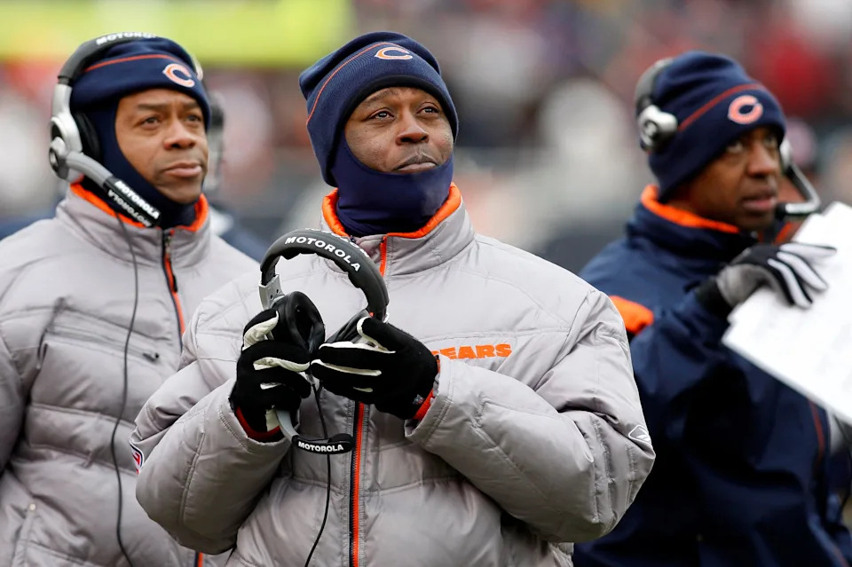 Chicago Bears head coach Lovie Smith (center) looks up at the replay board.