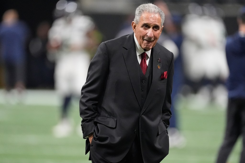 Atlanta Falcons owner Arthur Blank walks on the field.