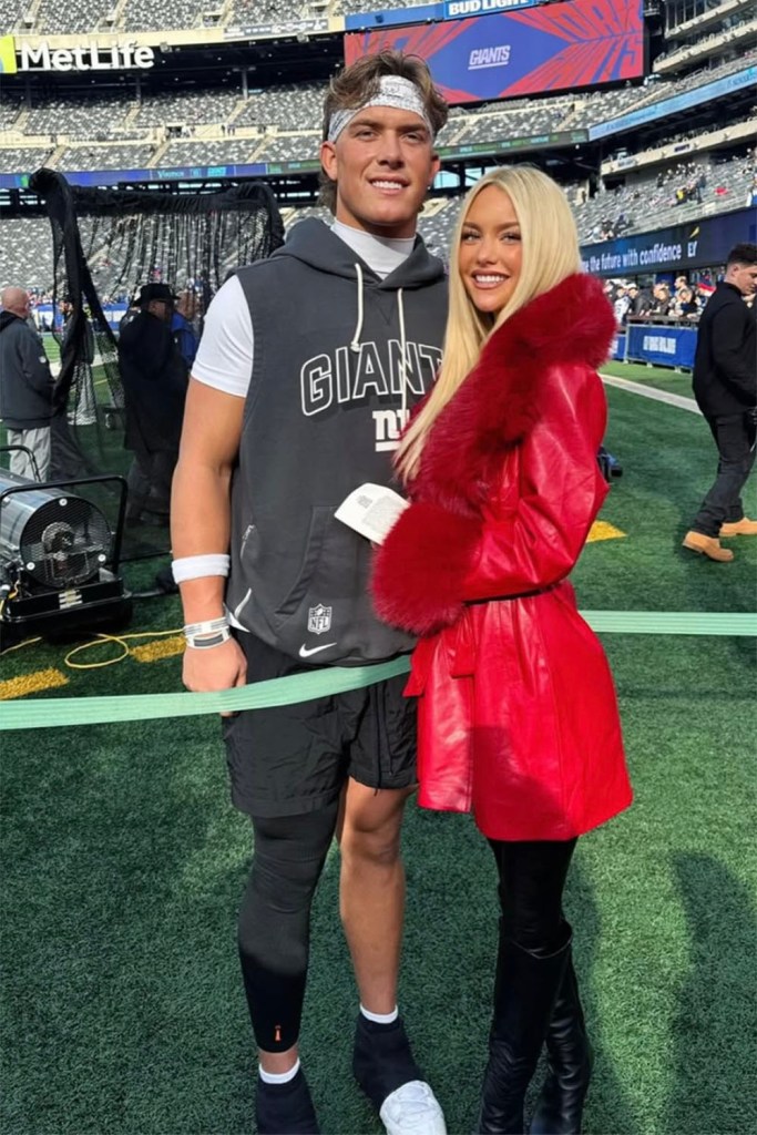 Giants quarterback Jaxson Dart and his girlfriend Marissa Ayers on the sideline at MetLife Stadium during the 2025-26 season. 