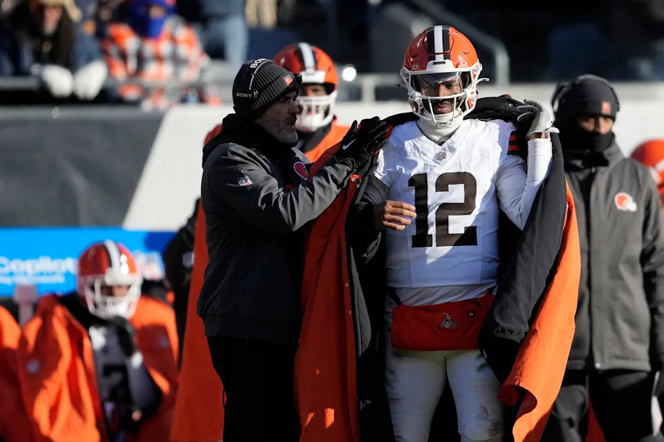 CHICAGO, ILLINOIS - DECEMBER 14: Head coach Kevin Stefanski of the Cleveland Browns talks with Shedeur Sanders #12 during the second half against the Chicago Bears at Soldier Field on December 14, 2025 in Chicago, Illinois. (Photo by Patrick McDermott/Getty Images)
