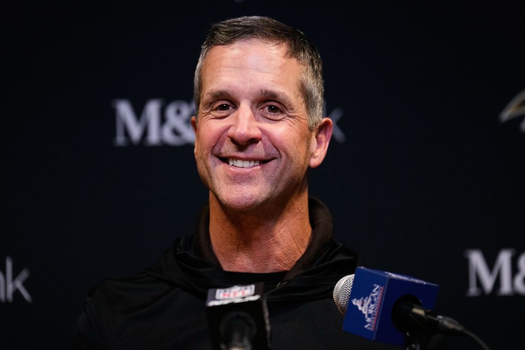 John Harbaugh speaking at a press conference.
