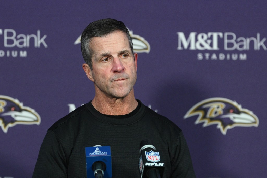Baltimore Ravens head coach John Harbaugh speaking at a news conference.
