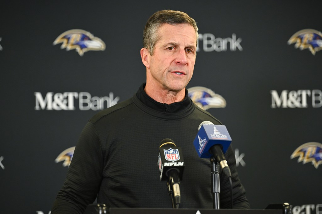 Baltimore Ravens head coach John Harbaugh speaking at a news conference.
