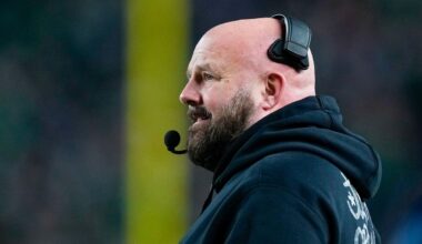 Brian Daboll stands on football sideline with headset on