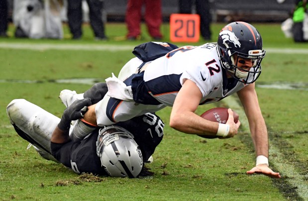 Denver Broncos quarterback Paxton Lynch (12) ...