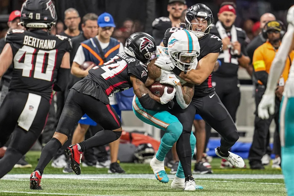 Oct 26, 2025; Atlanta, Georgia, USA; Miami Dolphins wide receiver Cedrick Wilson Jr. (19) is tackled by Atlanta Falcons cornerback A.J. Terrell Jr. (24) and linebacker Kaden Elliss (55) during the second half at Mercedes-Benz Stadium. Dale Zanine-Imagn Images