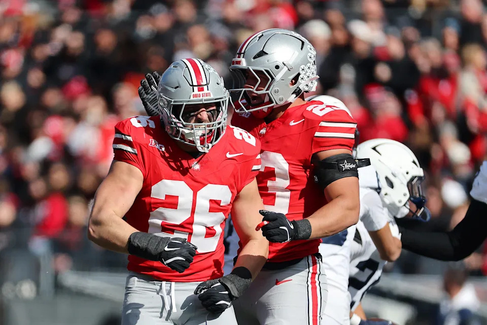 Nov 1, 2025; Columbus, Ohio, USA; Ohio State Buckeyes linebacker Payton Pierce (26) celebrates his tackle with linebacker Garrett Stover (23) during the second quarter against the Penn State Nittany Lions at Ohio Stadium. Mandatory Credit: Joseph Maiorana-Imagn Images