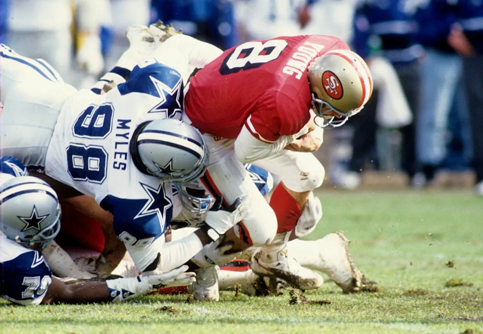 Dallas Cowboys linebacker Godfrey Myles brings down San Francisco 49ers quarterback Steve Young.
