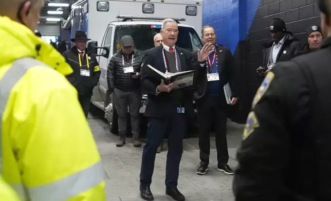 Chris Clark, Buffalo Bills Vice President of Security, center, meets with security personnel at Highmark Stadium before an NFL football game between the Philadelphia Eagles and Buffalo Bills, Sunday, Dec. 28, 2025. (AP Photo/Gene J. Puskar)