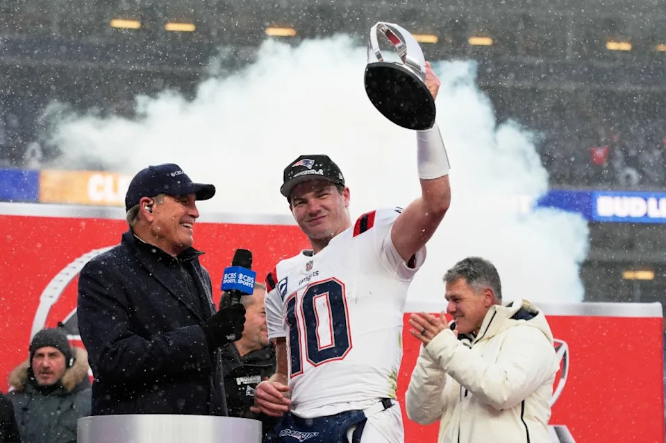 New England Patriots quarterback Drake Maye celebrates with the trophy after the AFC Championship after beating the Denver Broncos on Sunday, January, 25, 2026, in Denver. AP