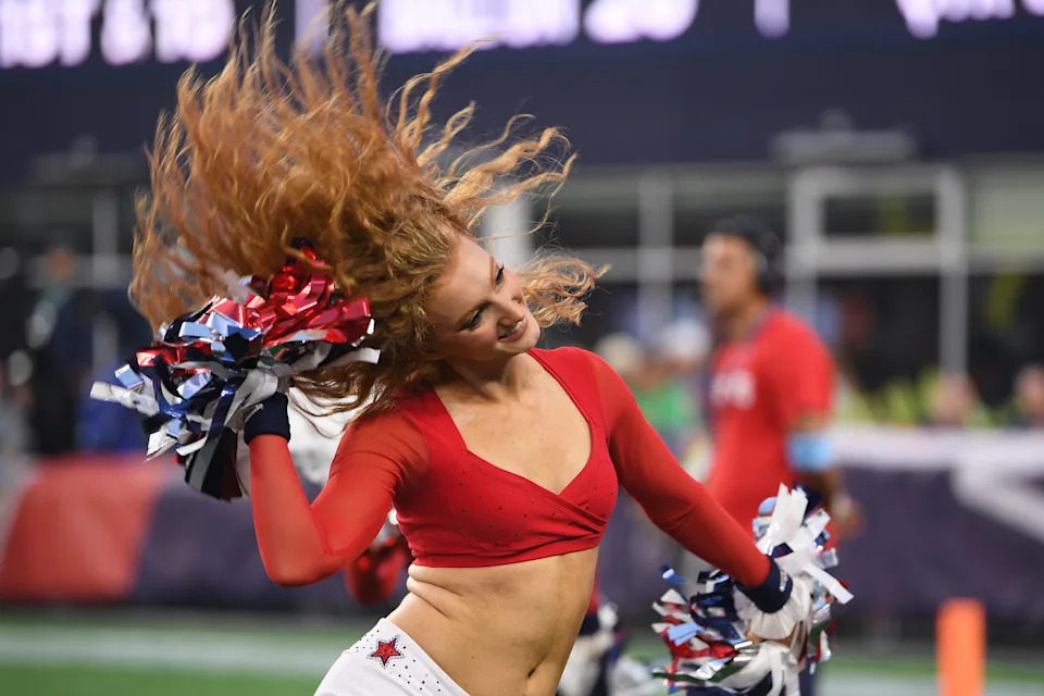A New England Patriots cheerleader performs during the first half.