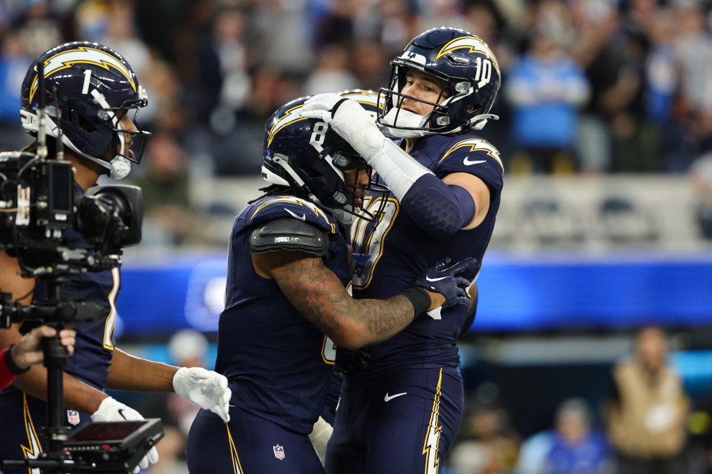 Los Angeles Chargers running back Omarion Hampton (8) celebrates his touchdown with quarterback Justin Herbert (10).