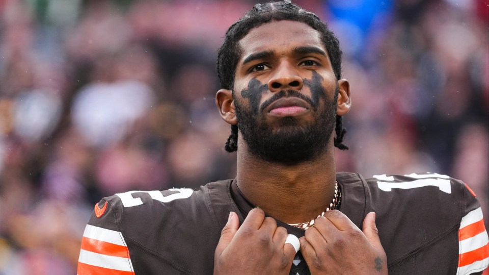 Shedeur Sanders #12 of the Cleveland Browns looks on from the sideline during the national anthem prior to an NFL football game