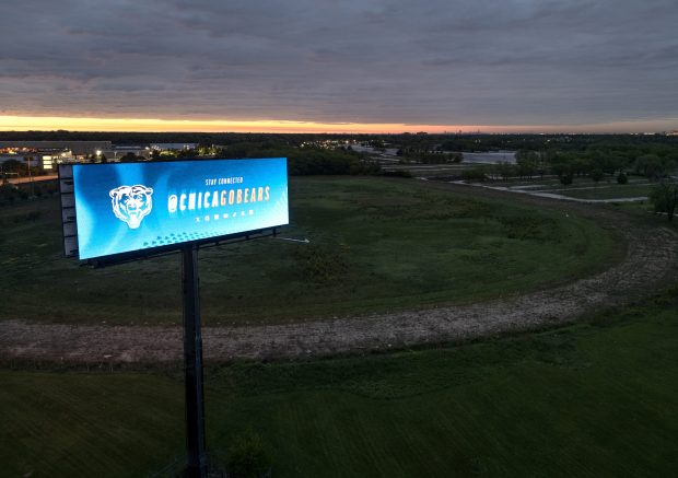 A Chicago Bears digital billboard located just off of Route 53 flashes advertisements at sunrise at the former Arlington International Racecourse on May 23, 2025, in Arlington Heights. The Chicago Bears may eventually make this the site of their new stadium and entertainment district. (Stacey Wescott/Chicago Tribune) 