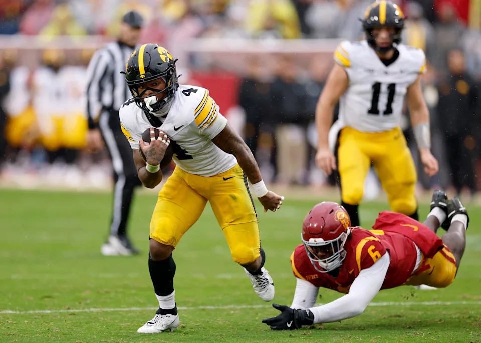 LOS ANGELES, CALIFORNIA - NOVEMBER 15: Jaziun Patterson #4 of the Iowa Hawkeyes avoids a tackle from Anthony Lucas #6 of the Southern California Trojans during the first half at Los Angeles Memorial Coliseum on November 15, 2025 in Los Angeles, California. (Photo by Harry How/Getty Images)
