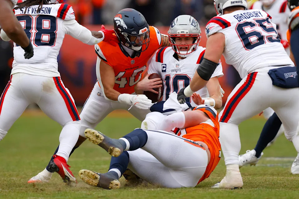 DENVER, COLORADO - JANUARY 25: Drake Maye #10 of the New England Patriots is sacked by Zach Allen #99 of the Denver Broncos during the second quarter in the AFC Championship Playoff game at Empower Field At Mile High on January 25, 2026 in Denver, Colorado. (Photo by Justin Edmonds/Getty Images)