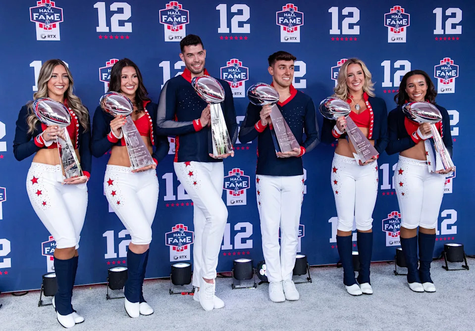 Cheerleaders hold the six Vince Lombardi trophies (Superbowl) won by the Patriots.