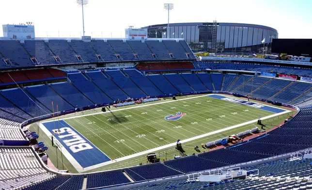 FILE - The existing Highmark Stadium, foreground, frames the construction on the new Highmark Stadium, upper right, which is scheduled to open with the 2026 season, shown before an NFL football game between the Buffalo Bills and the New England Patriots, Oct. 5, 2025, in Orchard Park, N.Y. (AP Photo/Gene J. Puskar, File)