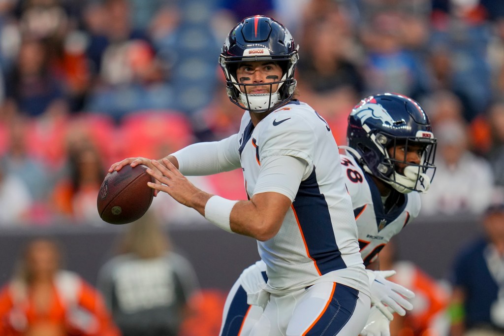 Denver Broncos quarterback Jarrett Stidham looks to pass.