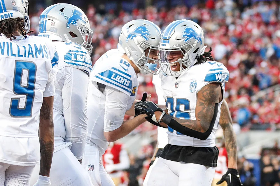 Lions running back Jahmyr Gibbs, right, celebrates a touchdown against 49ers with quarterback Jared Goff.