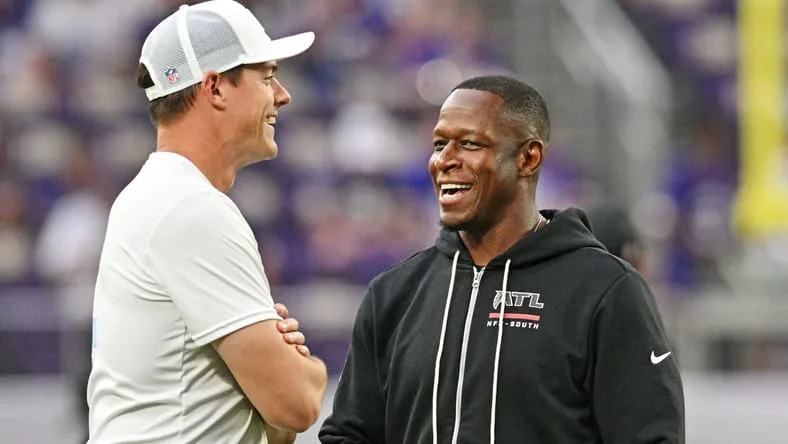Kevin O’Connell and Raheem Morris greet each other before a game at U.S. Bank Stadium.