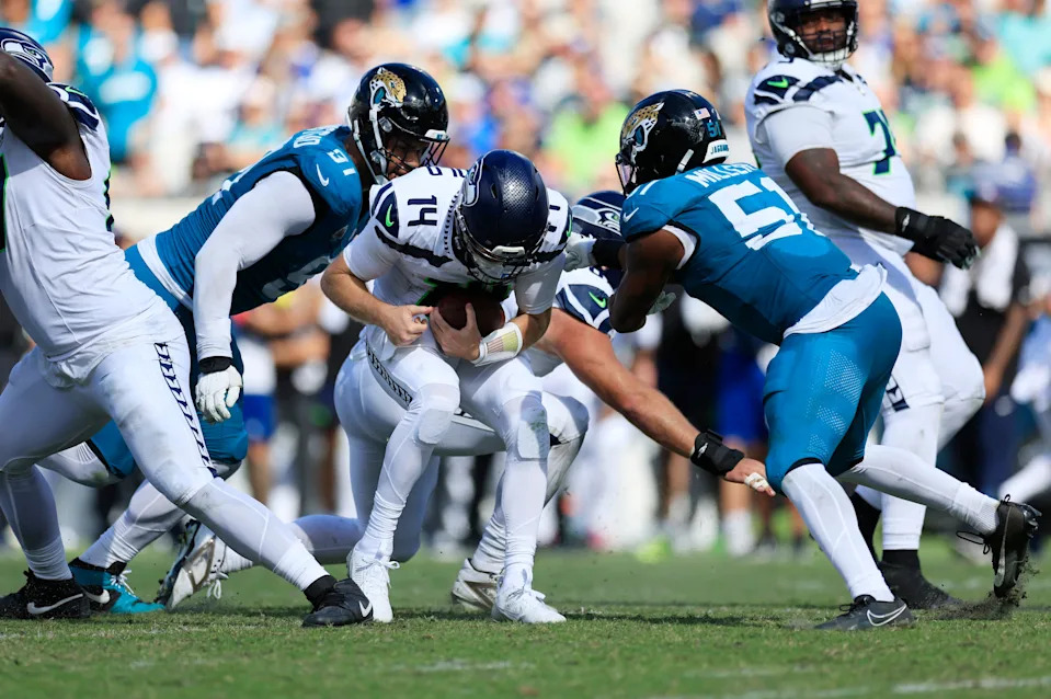 Jacksonville Jaguars defensive tackle Arik Armstead, left, and linebacker Ventrell Miller combine to sack Seattle Seahawks quarterback Sam Darnold.