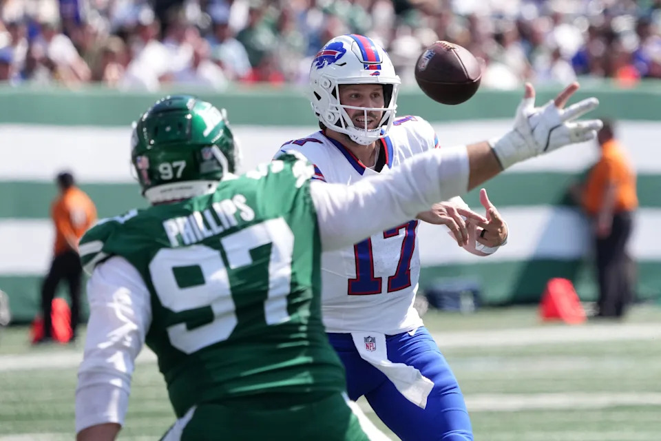 Sep 14, 2025; East Rutherford, New Jersey, USA; Buffalo Bills quarterback Josh Allen (17) makes a throw against New York Jets defensive tackle Harrison Phillips (97) during the first half at MetLife Stadium. Mandatory Credit: Robert Deutsch-Imagn Images