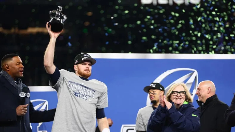 Sam Darnold celebrating with the NFC Championship trophy