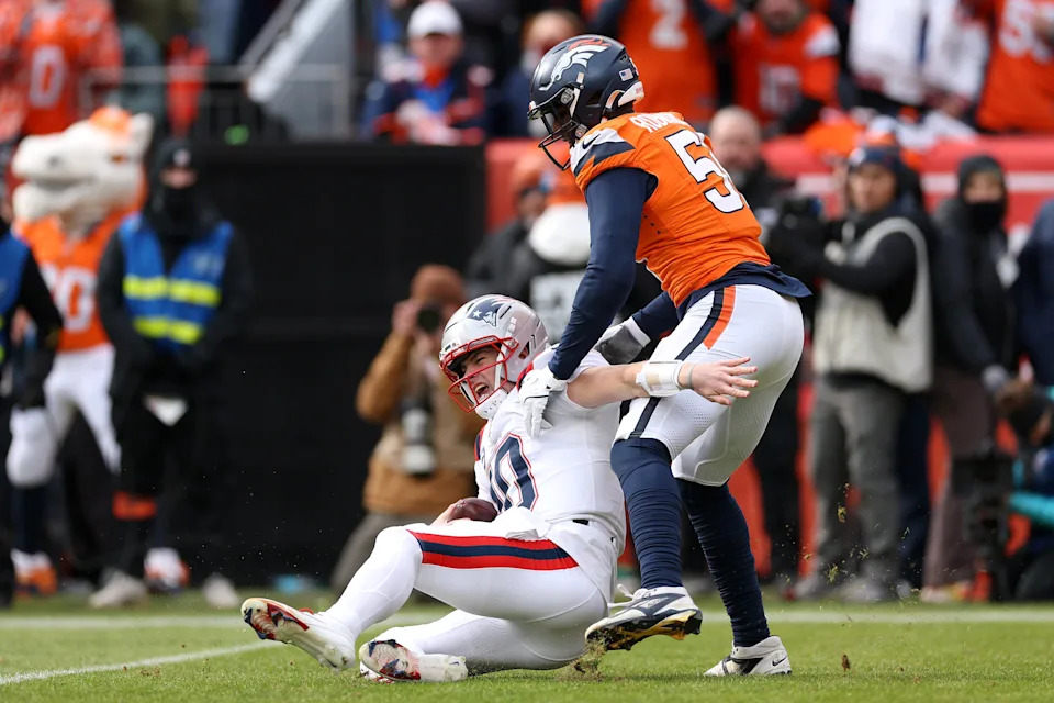 DENVER, COLORADO - JANUARY 25: Drake Maye #10 of the New England Patriots is sacked by Que Robinson #51 of the Denver Broncos during the first quarter in the AFC Championship Playoff game at Empower Field At Mile High on January 25, 2026 in Denver, Colorado. (Photo by Matthew Stockman/Getty Images)