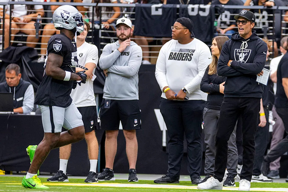 Las Vegas Raiders minority owner Tom Brady, far right, yells encouragement to players as they take the field during the first half of a Raiders training camp mock game at Allegiant Stadium on Saturday, Aug. 2, 2025, in Las Vegas. (L.E. Baskow/Las Vegas Review-Journal/Tribune News Service via Getty Images)