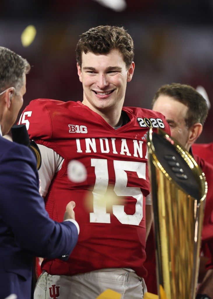 Fernando Mendoza #15 of the Indiana Hoosiers celebrates with the championship trophy.