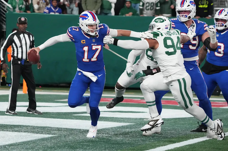 East Rutherford, NJ -- October 14, 2024 -- Josh Allen of Buffalo gets out of the grasp of Solomon Thomas of the Jets in the first half. The Buffalo Bills came to MetLife Stadium to play the NY Jets. The Jets played their first game under new interim head coach Jeff Ulbrich.