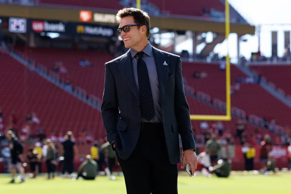 Fox Sports lead analyst Tom Brady stands on the field prior to an NFL football game between the Los Angeles Rams and the San Francisco 49ers at Levi's Stadium on November 09, 2025