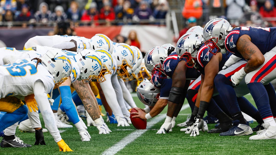 FOXBOROUGH, MA - DECEMBER 28: The Los Angeles Chargers and the New England Patriots line up for the snap at the line of scrimmage during the game at Gillette Stadium on December 28, 2024 in Foxborough, Massachusetts.
