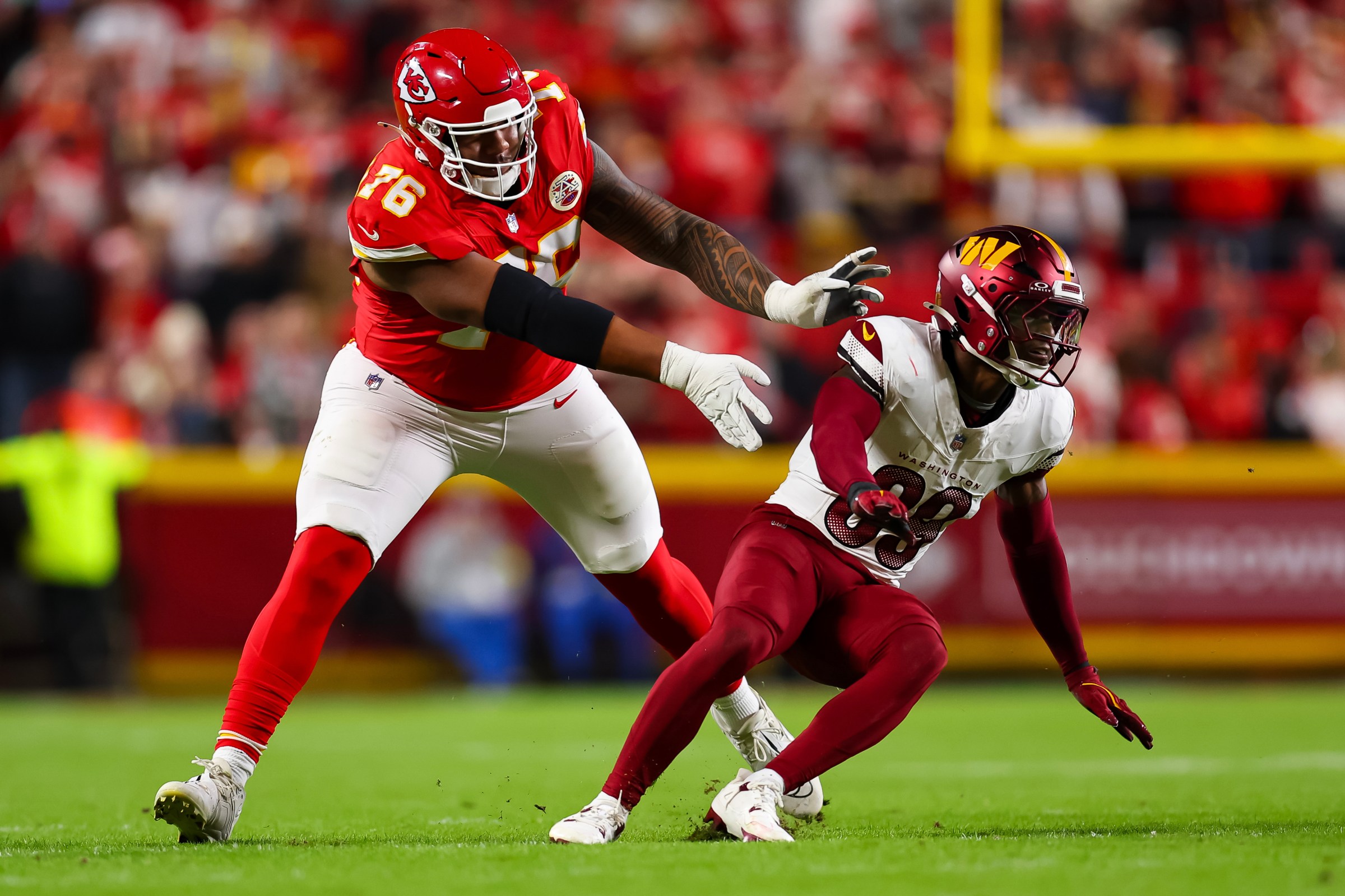 KANSAS CITY, MISSOURI - OCTOBER 27: Kingsley Suamataia #76 of the Kansas City Chiefs runs downfield against Jeremy Reaves #39 of the Washington Commanders during the first quarter at Arrowhead Stadium on October 27, 2025 in Kansas City, Missouri. (Photo by Brooke Sutton/Getty Images)