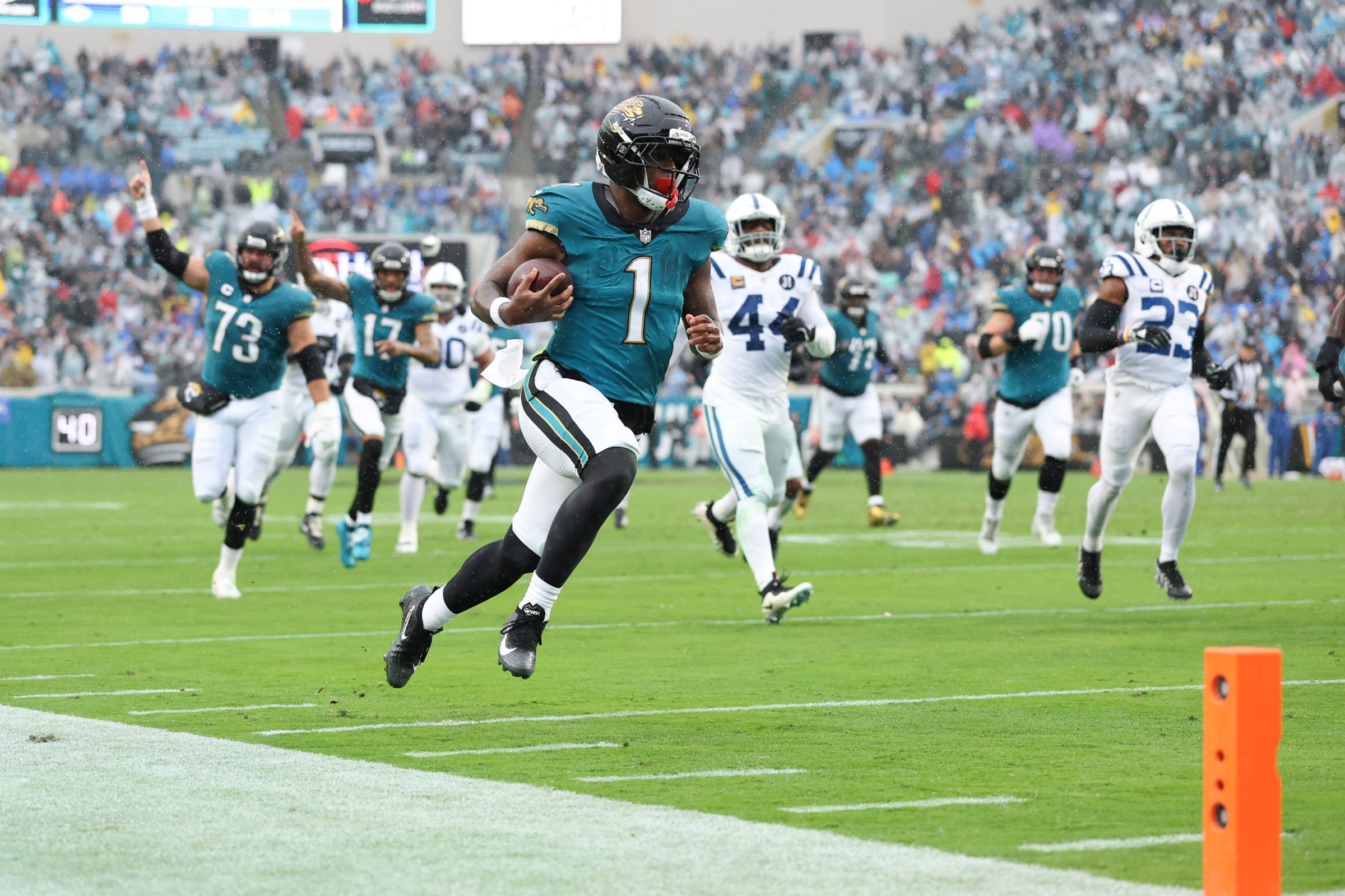 JACKSONVILLE, FLORIDA - DECEMBER 7: Travis Etienne Jr. #1 of the Jacksonville Jaguars runs the ball for a touchdown during the second quarter of an NFL 2025 game against the Indianapolis Colts at Everbank Stadium on December 7, 2025 in Jacksonville, Florida. (Photo by Logan Bowles/Getty Images)