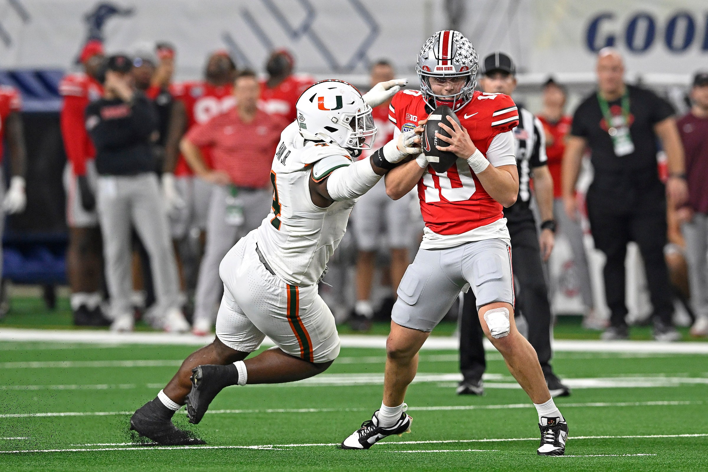 ARLINGTON, TX - DECEMBER 31: Miami defensive lineman Rueben Bain Jr. (4) pressures Ohio State quarterback Julian Sayin (10) in the second quarter as the Miami Hurricanes faced the Ohio State Buckeyes in the Goodyear Cotton Bowl Classic on December 31, 2025, at AT&T Stadium in Arlington, Texas. (Photo by Samuel Lewis/Icon Sportswire via Getty Images)
