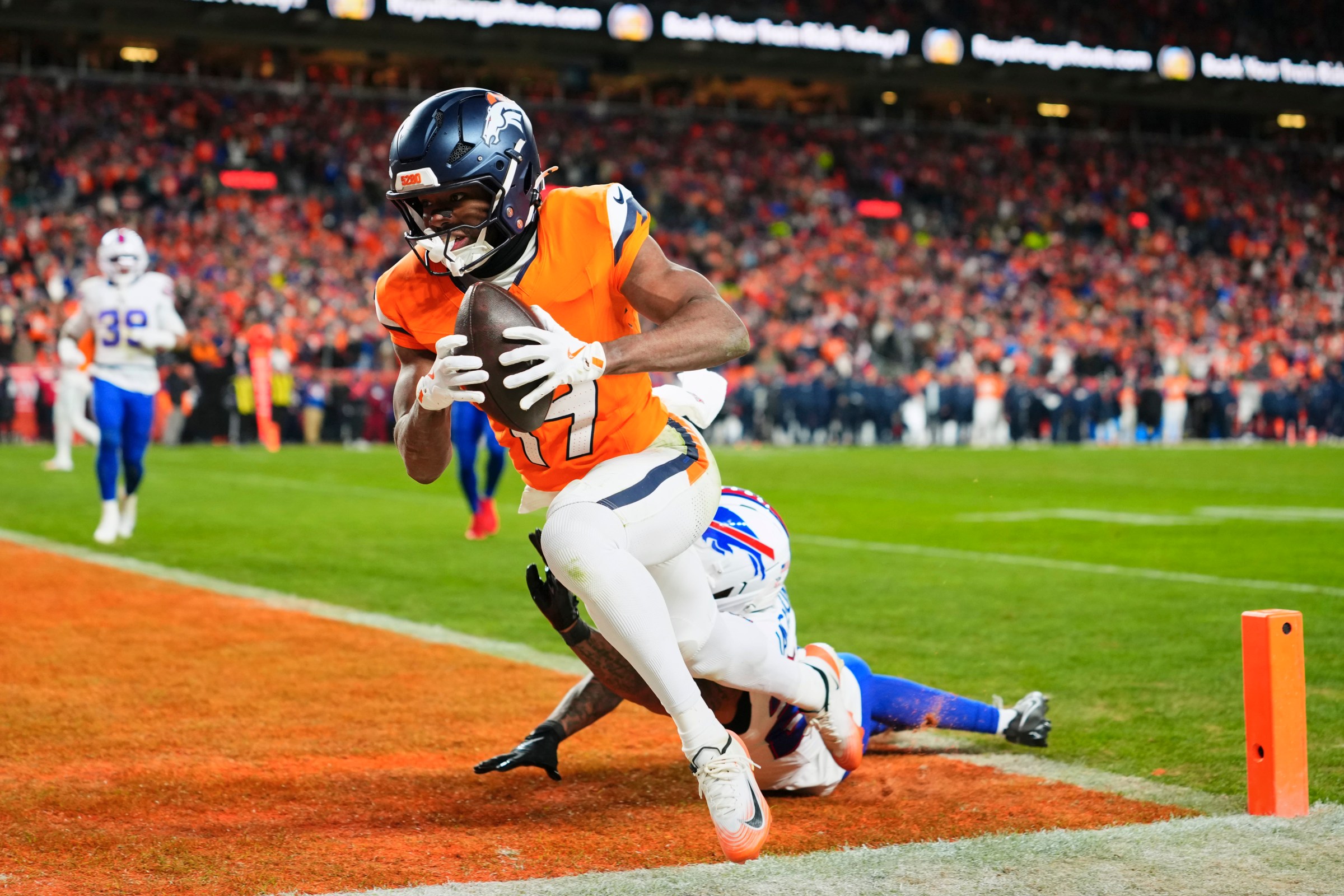 DENVER, CO - JANUARY 17: Marvin Mims Jr. #19 of the Denver Broncos scores a touchdown against the Buffalo Bills during the second half of an AFC Divisional Playoff game at Empower Field At Mile High on January 17, 2026 in Denver, Colorado. (Photo by Cooper Neill/Getty Images)