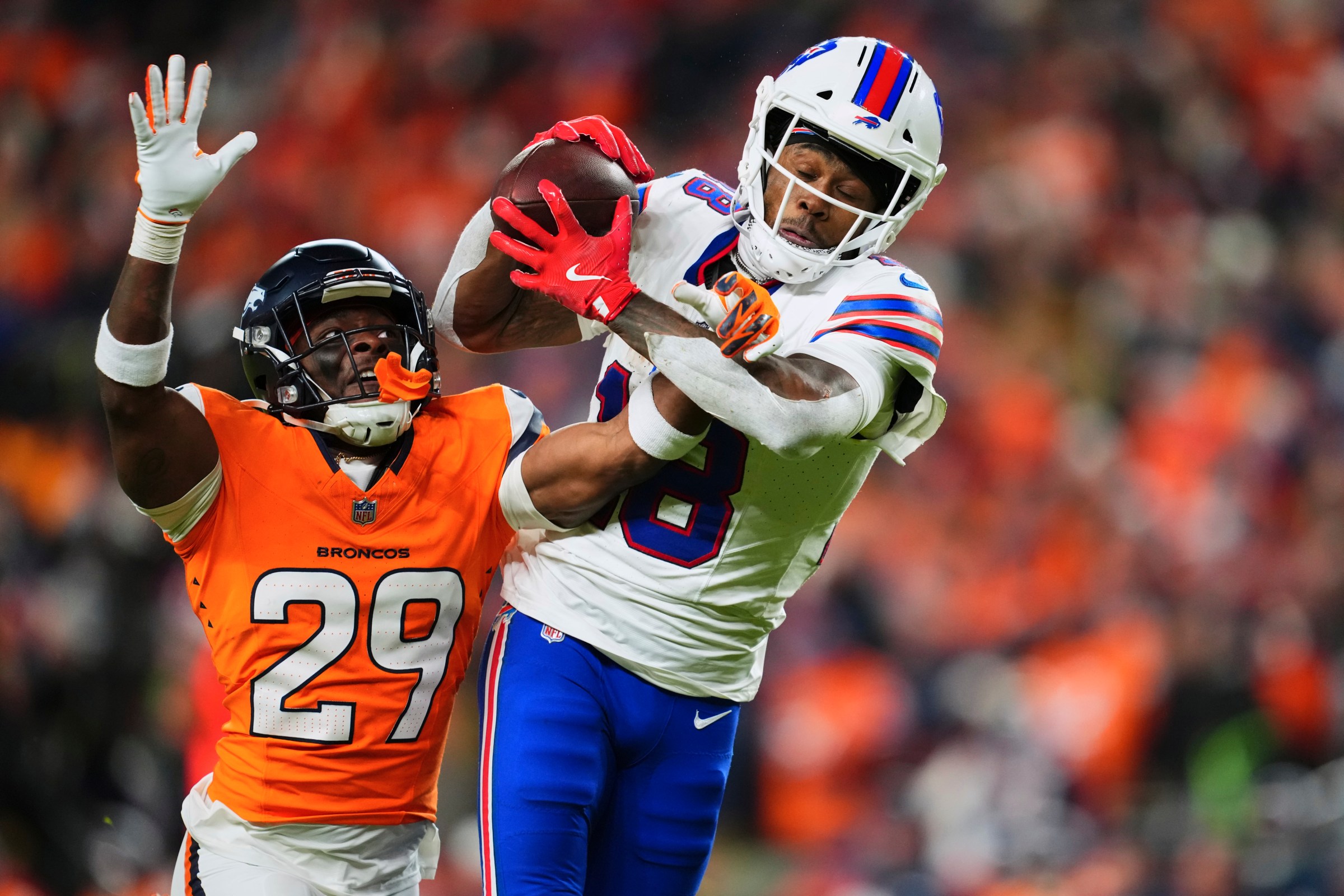 DENVER, CO - JANUARY 17: Ja’Quan McMillian #29 of the Denver Broncos fights for the ball with Brandin Cooks #18 of the Buffalo Bills during overtime of an AFC Divisional Playoff game at Empower Field At Mile High on January 17, 2026 in Denver, Colorado. (Photo by Cooper Neill/Getty Images)