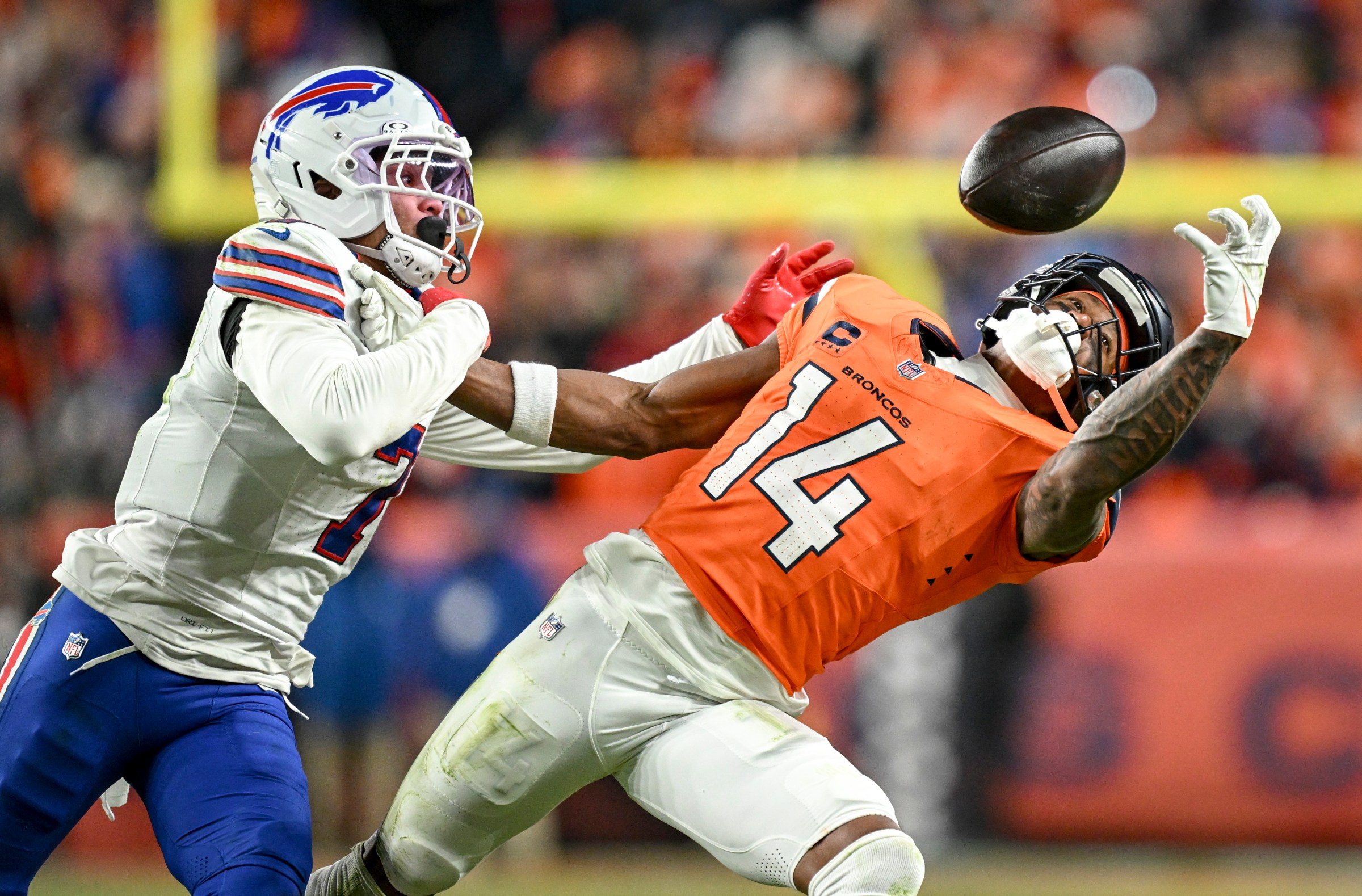 DENVER , CO - JANUARY 17: Courtland Sutton (14) of the Denver Broncos draws a key pass interference call on Taron Johnson (7) of the Buffalo Bills during overtime of the Broncos’ 33-30 win at Empower Field at Mile High in Denver, Colorado on Saturday, January 17, 2026. (Photo by AAron Ontiveroz/The Denver Post)