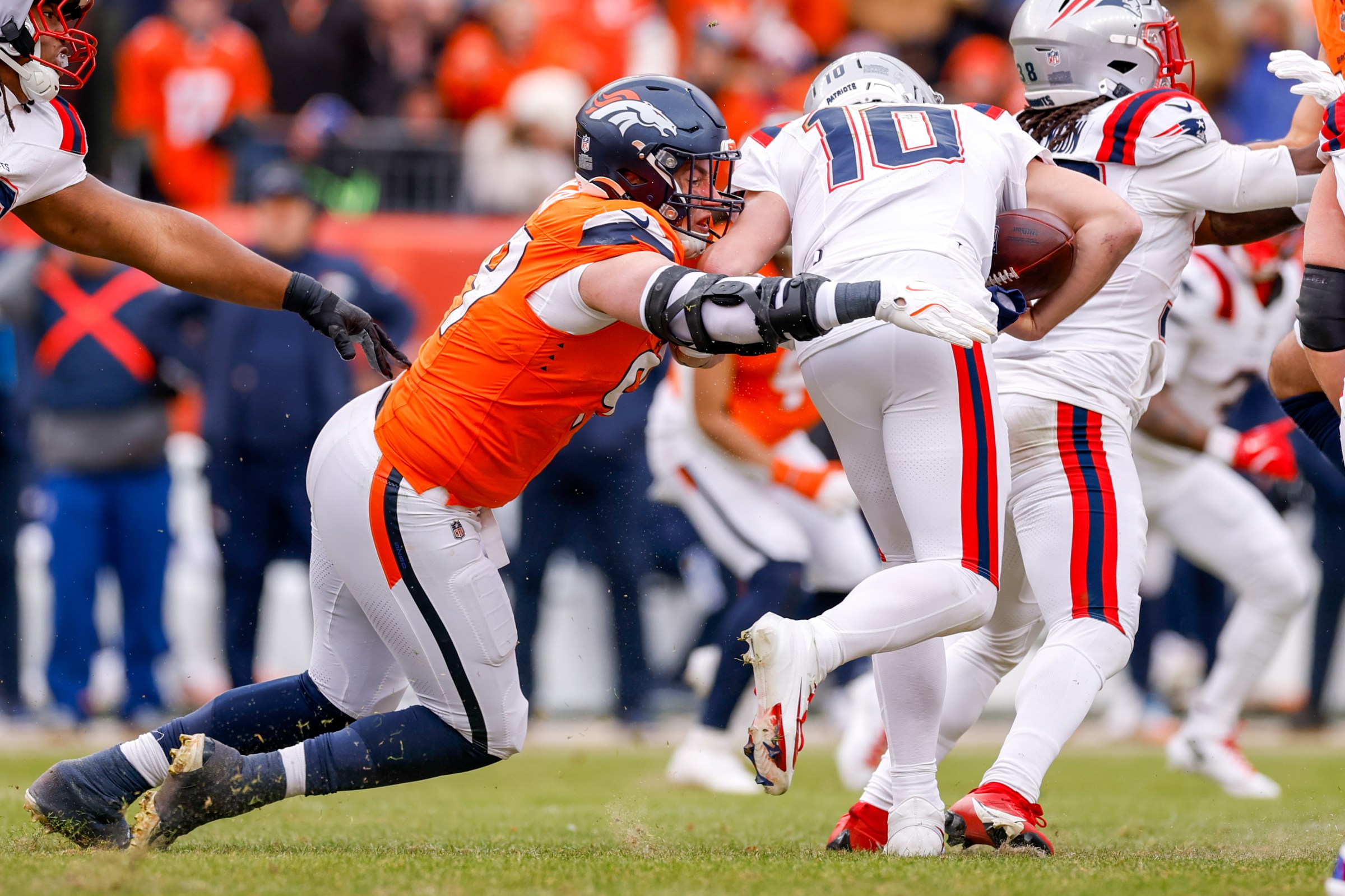 DENVER, COLORADO - JANUARY 25: Zach Allen #99 of the Denver Broncos sacks Drake Maye #10 of the New England Patriots during the second quarter of the AFC Championship game at Empower Field At Mile High on January 25, 2026 in Denver, Colorado. (Photo by Lauren Leigh Bacho/Getty Images)