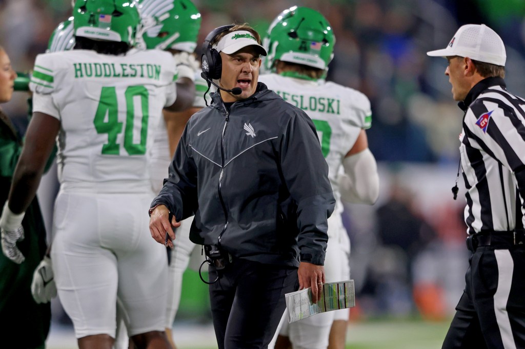 North Texas Mean Green head coach Eric Morris talks to an official during the 2025 American Conference Football Championship against the Tulane Green Wave.