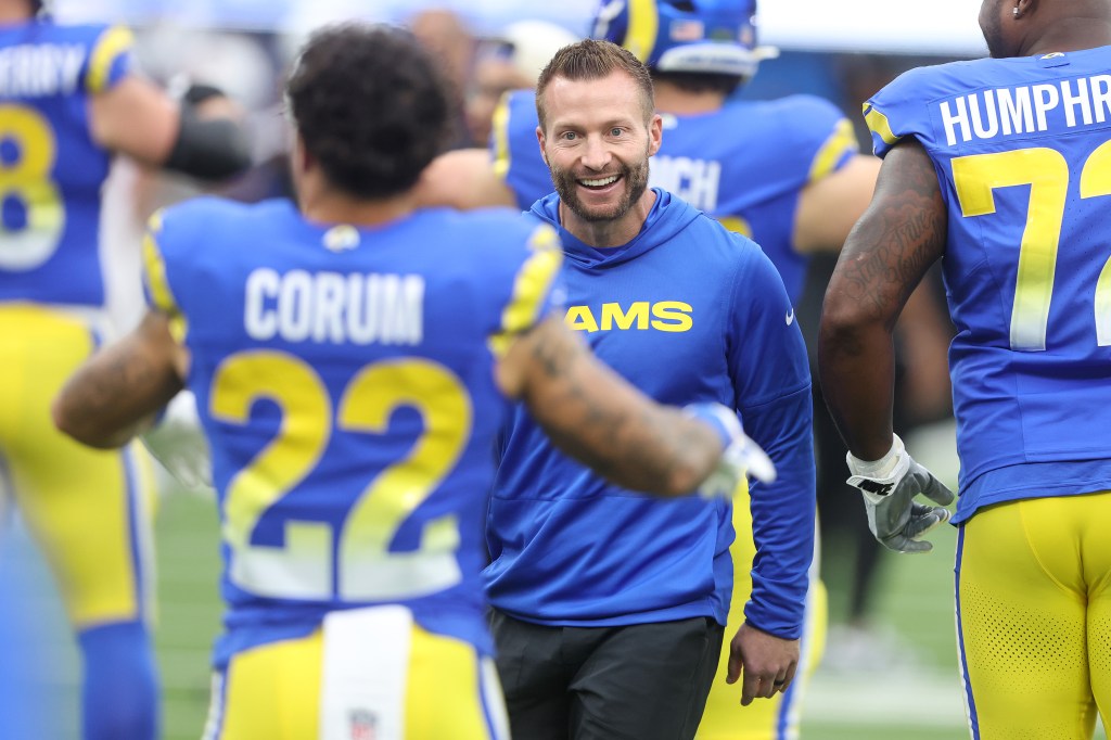 Head coach Sean McVay talks with Blake Corum of the Los Angeles Rams.